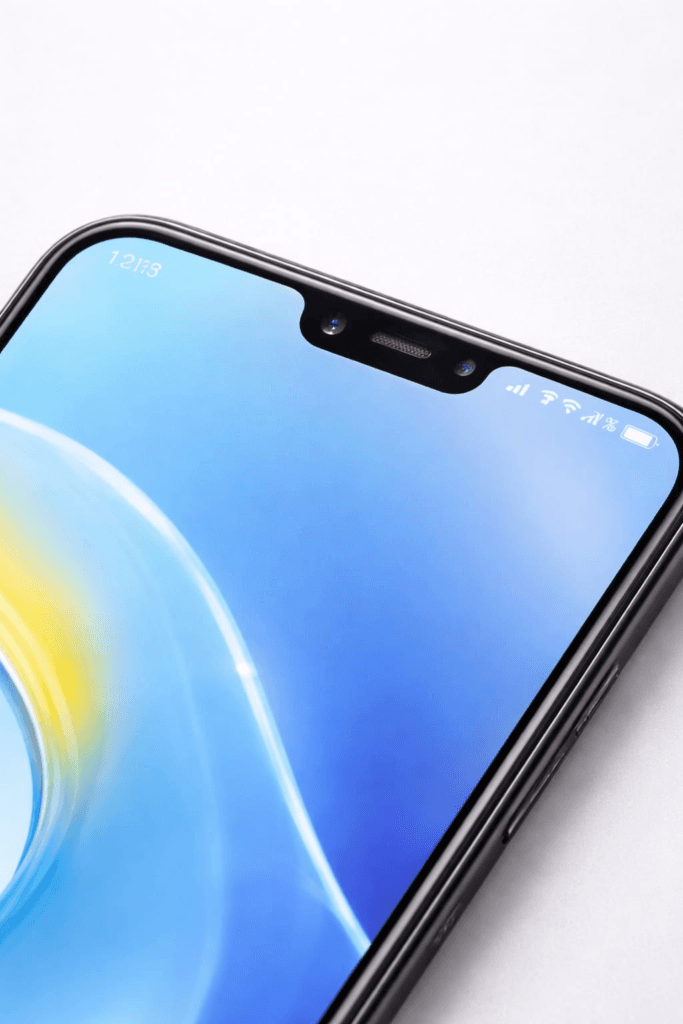 Close-up of wide notch smartphone display with tempered glass, highlighting accurate notch cut for front camera and sensors without obstruction.